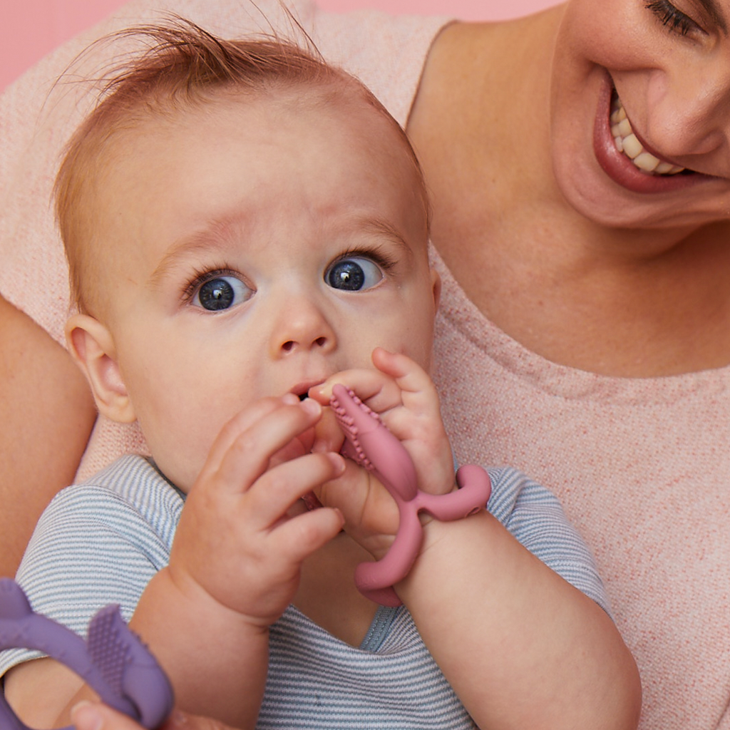 child with Wrist Teether - Blush - b.box for kids